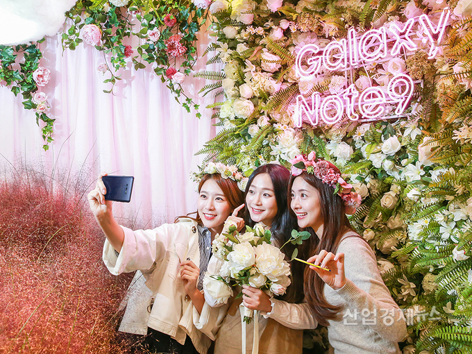 서울 영등포 타임스퀘어 아트리움 광장 갤럭시 스튜디오에 마련된 핑크뮬리 테마 포토존에서 '갤럭시 노트9' 팬들이 '스마트S펜'의 블루투스 기능을 활용해 인생샷을 찍고 있다.